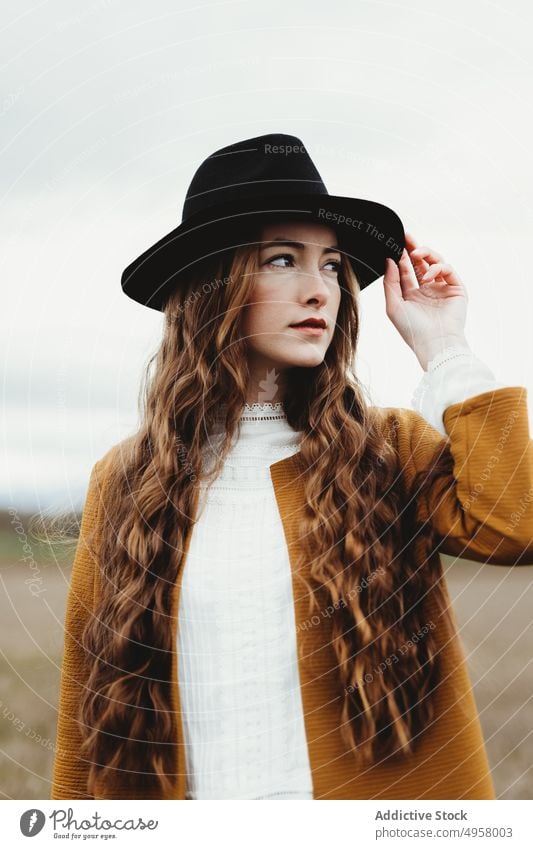 Young hipster woman in the countryside girl nature young person lifestyle hat casual fashion background caucasian natural face stylish retro travel beautiful