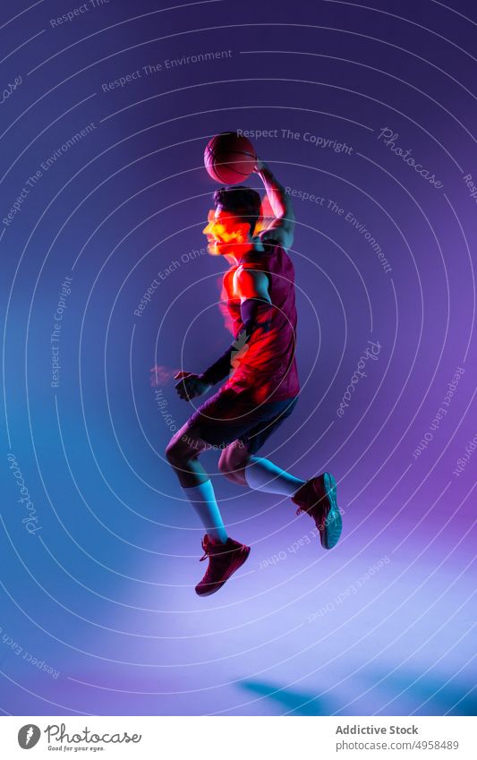 Studio Shot Of Basketball Player In The Studio with purple background action advertising art athlete basketball blur colorful competition concept contemporary