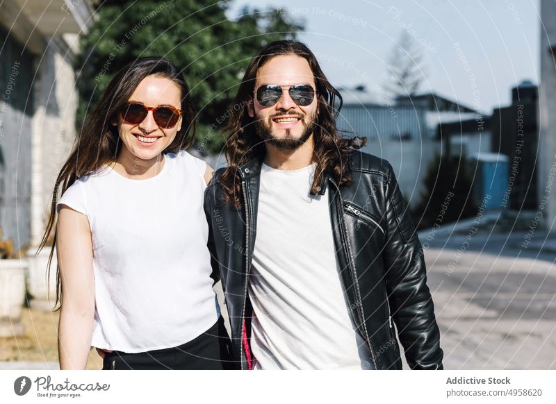Latin American couple standing close on street embrace love relationship romance soulmate sincere enjoy street style town portrait lifestyle leather jacket walk