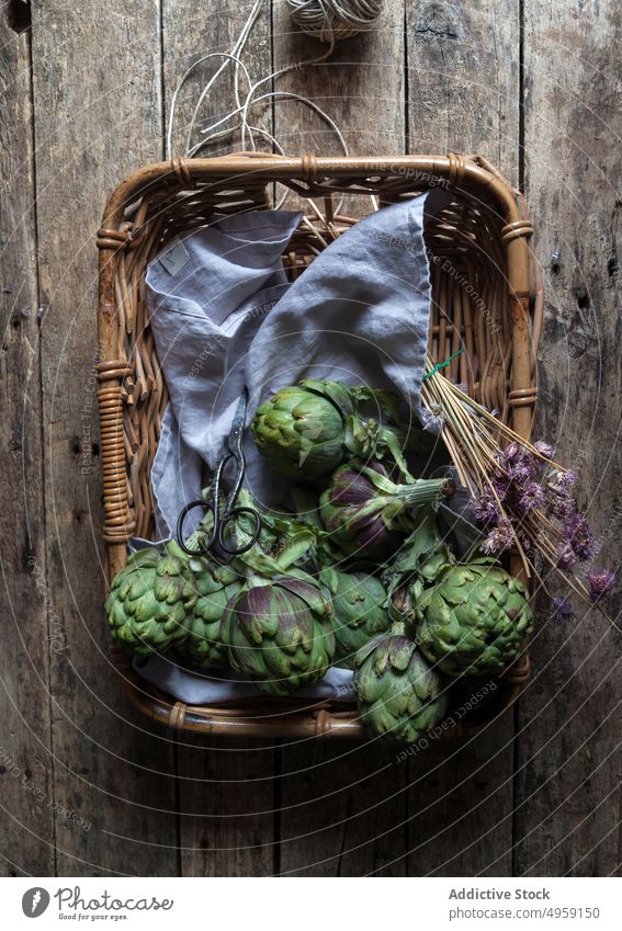 Fresh artichokes placed in basket fresh green wicker napkin decoration flower bunch vegetable food healthy ripe vegetarian plant agriculture organic diet