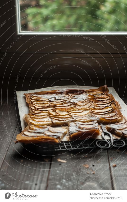 Served apple pie in pieces on parchment fresh wood rustic window frangipane homemade daylight brown confectionery organic warm aroma dessert food cuisine season