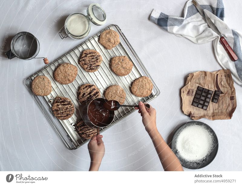 Anonymous woman coating cookies with chocolate hand delicious holding sugar mouthwatering party food bowl recipe homemade food cookies stack step by step