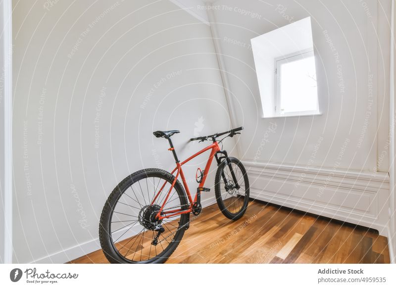 red bicycle in a empty room apartment indoor interior floor parquet home modern new house wall flat contemporary estate property residential window light white