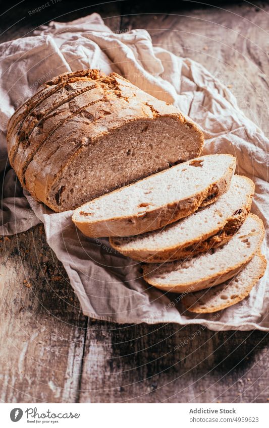 Sliced wholegrain bread scattered on wooden table slice fresh loaf baked nutrition rustic food kitchen bakery homemade meal ingredient gourmet tasty rye product