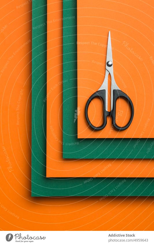 Scissors on green and orange cardboard background clean clipping color colorful concept craft cut cutter design geometric object paper patter scissors shadow