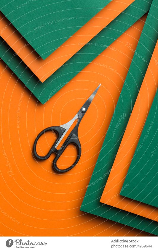 Scissors on green and orange cardboard background clean clipping color colorful concept craft cut cutter design geometric object paper patter scissors shadow