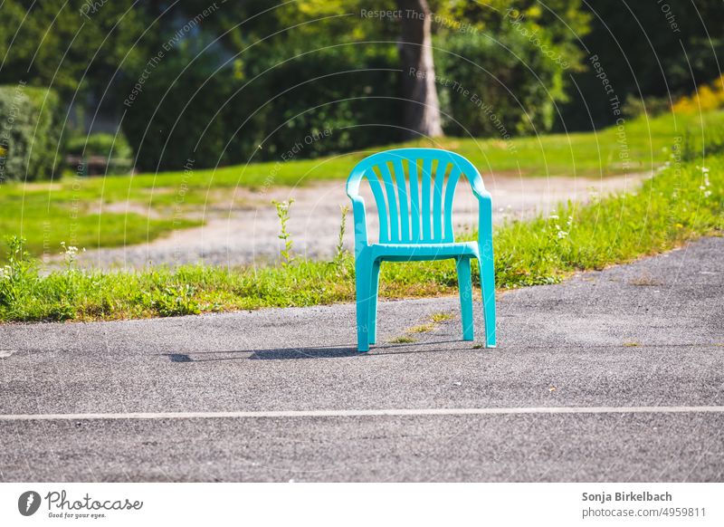 Lonely turquoise garden chair on the roadside in the green XD Garden chair Green space Outdoor furniture Break rest Seating Furniture Colour photo Deserted