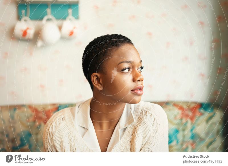 African American woman with short hair lifestyle resting female african american relax apartment comfort home sitting ethnic young thoughtful beautiful pretty