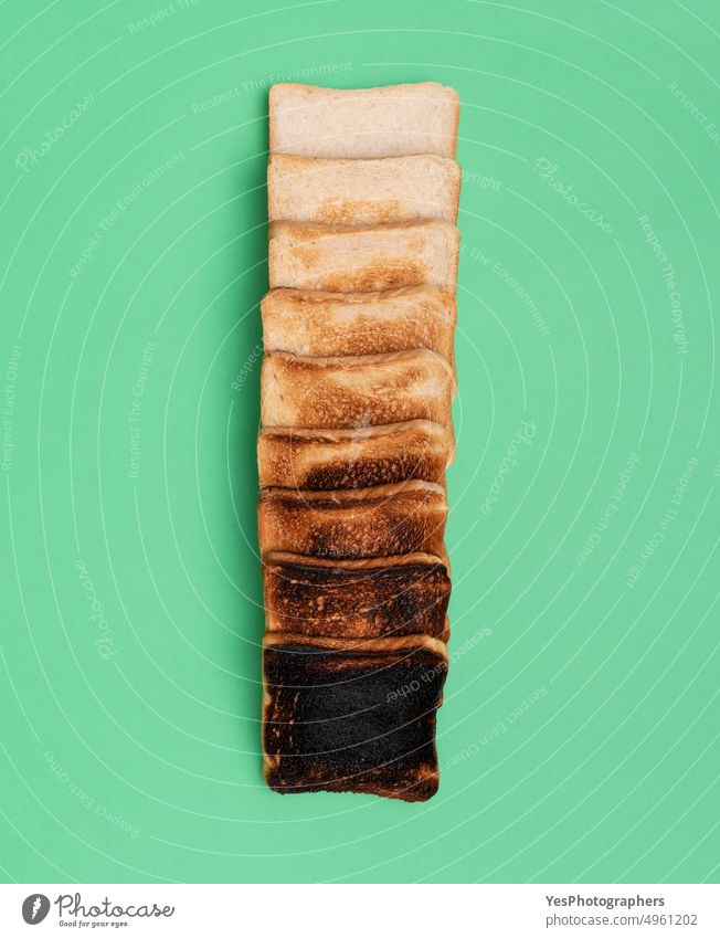 Toasted bread variety on a green table, top view. above aligned arranged assortment background breakfast bright brown burnt carbs color delicious flat lay food