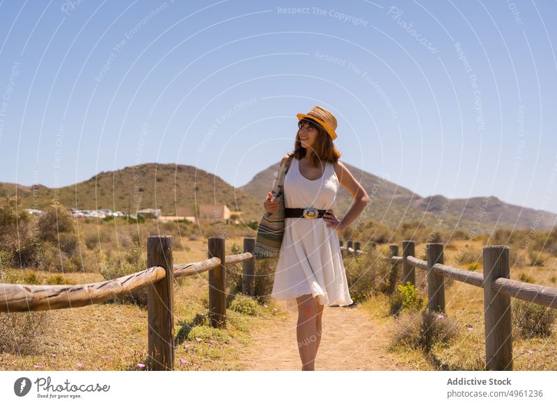 Woman walking along path in mountainous valley woman summer vacation natural park highland holiday travel female cabo de gata almeria spain dress carefree