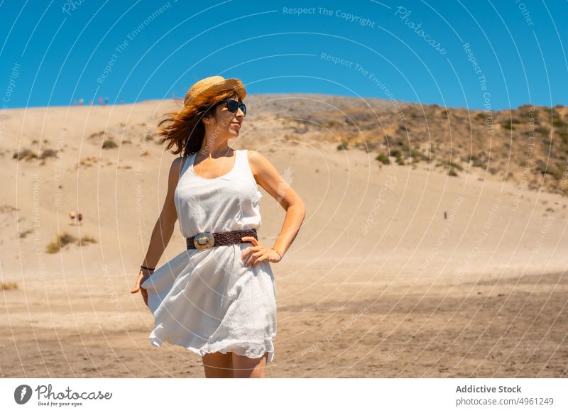 Delighted woman standing on beach in summer sand vacation carefree enjoy holiday female cabo de gata almeria spain happy shore nature dress park cheerful
