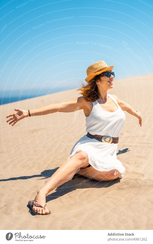 Smiling woman in dress on sandy beach in summer vacation seashore holiday smile enjoy sunhat female cabo de gata almeria spain natural park cheerful happy