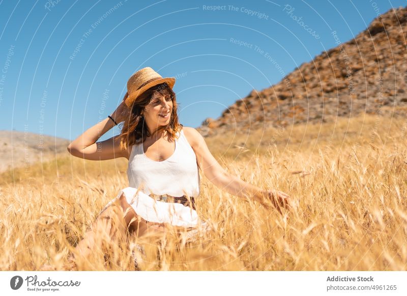 Content woman in dry field in mountains in summer vacation highland natural park enjoy carefree female cabo de gata almeria spain holiday smile relax happy