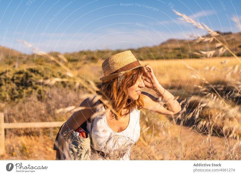Content woman in dry field in mountains in summer vacation highland natural park enjoy carefree female cabo de gata almeria spain holiday smile relax happy