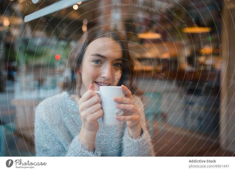 Woman drinking coffee in cafe woman dreamy thoughtful window cafeteria beverage enjoy female delicious tasty sit table tranquil serene cup cozy fresh young