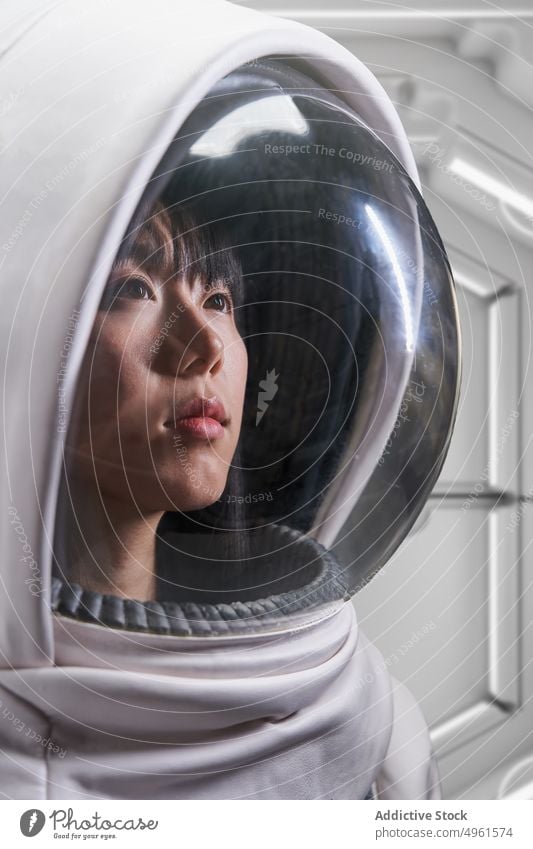 Female cosmonaut in futuristic spacesuit woman astronaut mission costume helmet spaceship brave cosmos protect female young asian chinese japanese safety future