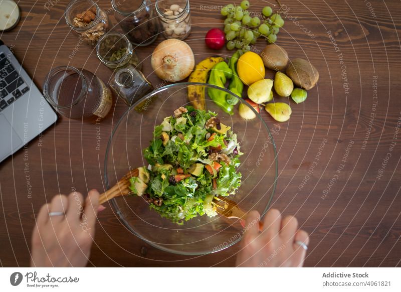 Crop unrecognizable female preparing yummy salad in kitchen woman cook healthy food stir vitamin meal vegetable delicious fruit housewife brunette casual bowl