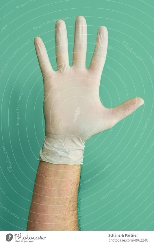 Man hand with disposable rubber glove arm Thumb Unicoloured colored background Fingers exempt Free space Isolated Image gesture Gesture Hand metaphor Close-up
