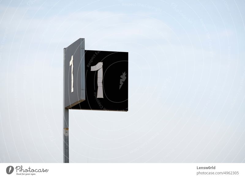 A sign with the number 1 on it concept direction first number one shape symbol leader