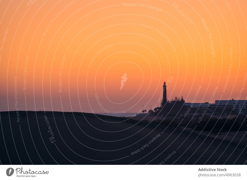 Silhouette of lighthouse against sundown sky shore sunset sea nature tower silhouette evening navigate marine maspalomas lighthouse gran canaria canary islands