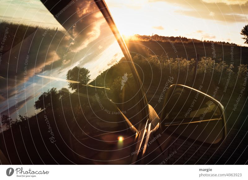 Sunset in the car window Motor vehicle Sunlight Mirror Motoring Deserted Exterior shot Driving Vehicle Transport Car Road traffic Means of transport Movement