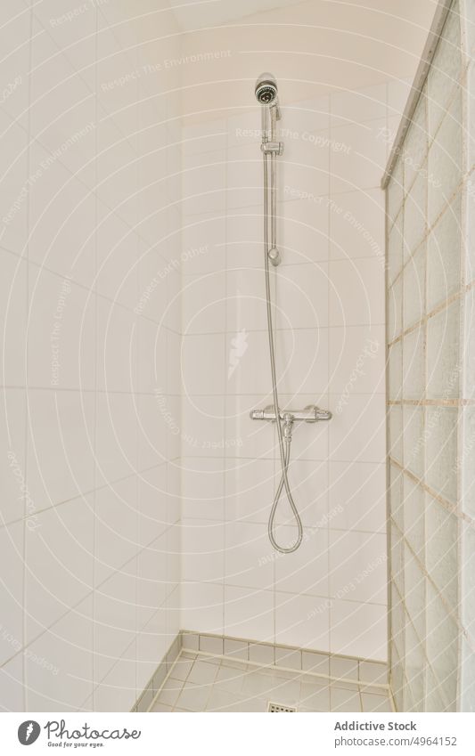 Shower cabin in light bathroom shower hose washroom style design interior hygiene daily private tile everyday sanitary routine clear stainless appliance modern