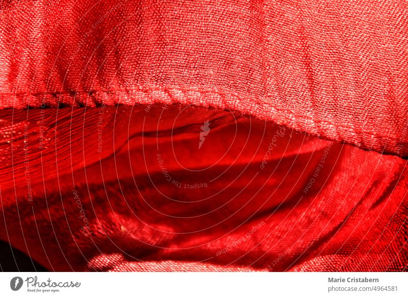 Close up of the texture and detail of of a red linen fabric macro color pattern background textile fashion abstract material backdrop cloth style design
