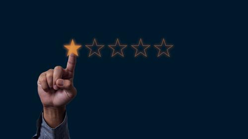 Businessman hand touches five stars rating feedback rating and positive customer review experience on virtual screen. service survey excellent customer service