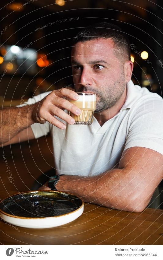 Middle aged man sitting in a bar having breakfast adult african american attractive beverage business businessman casual caucasian caucasian appearance coffee