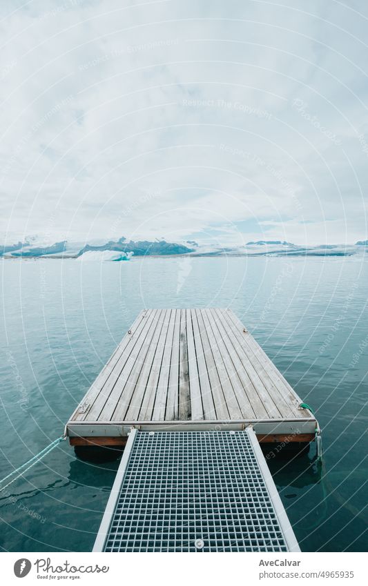 Tranquil pier backgrounds landscape of the Jokursalron scene. Freedom liberty and scape concept. Natural and wild Iceland view. Adventure vacations healthy lifestyle backpacking. Follow your dreams