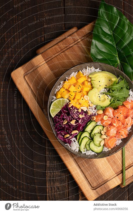 Delicious poke bowl with assorted veggies rice and salmon avocado mango asian food chopstick healthy food cucumber dish cuisine fish meal delicious tradition