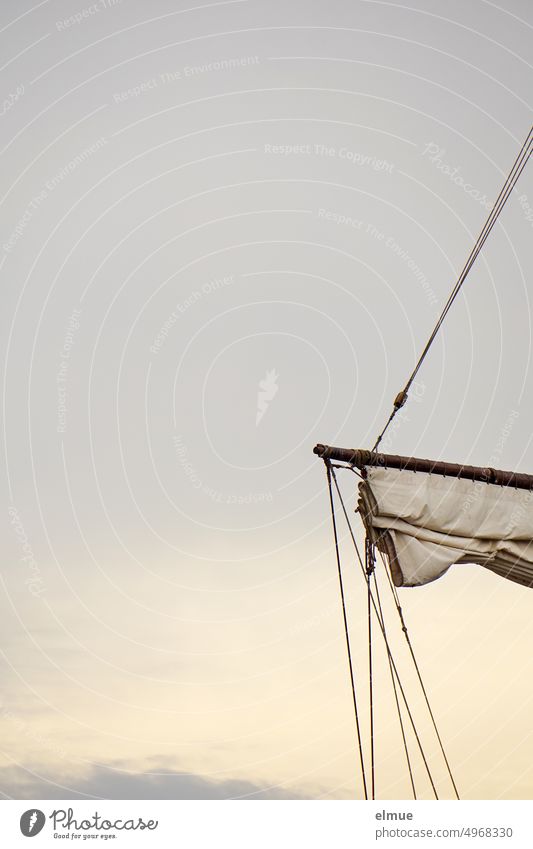 Partial view of retracted sail of old sailing ship against gray sky Sailing ship cog means of transport Navigation Windjammer Tall ship caravel one-master