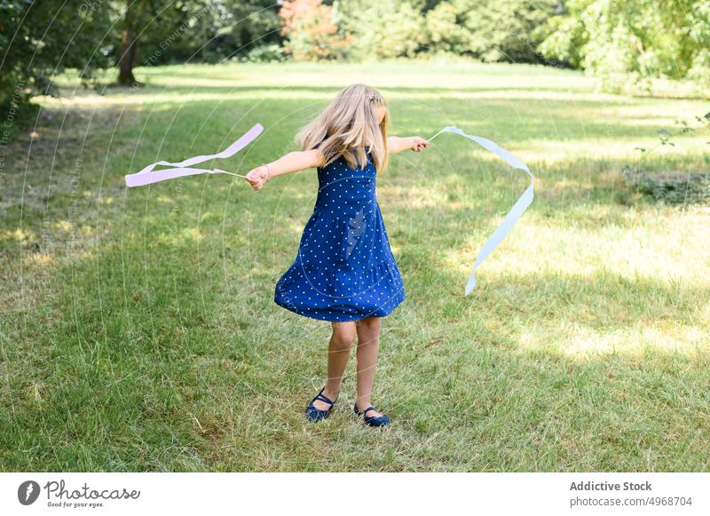 Girl dancing with ribbons in nature girl dance spin around countryside having fun summer weekend lawn freedom grass daytime child kid season activity childhood