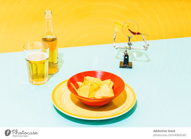 Tortilla chips near beer and magnifying glass tortilla pepper chili bowl concept