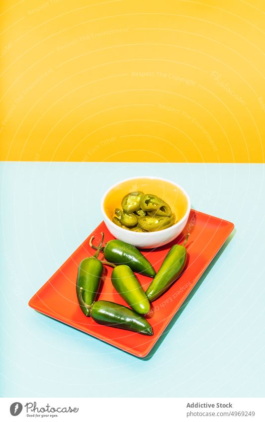 Fresh and marinated jalapenos on plate pepper fresh food cuisine raw colorful bright gourmet organic natural culinary uncooked meal tradition mexican hot