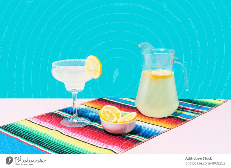 Fresh lemonade on colorful rug fresh drink blanket bright jug glass citrus beverage cool cold mexican tradition fruit refreshment juice slice vitamin healthy