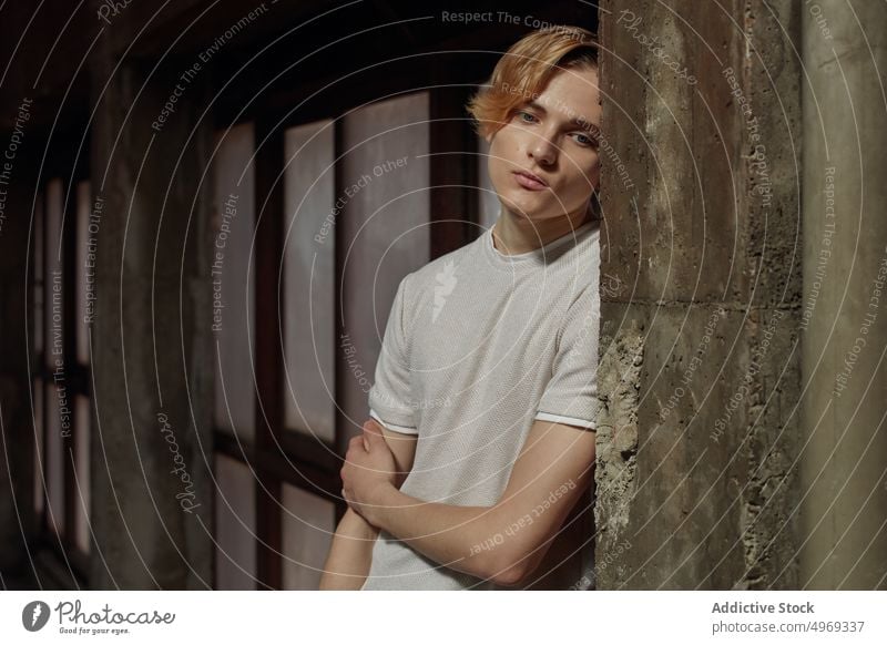 Young male standing near wall man posing model window handsome relaxed urban trendy stylish summer young guy attractive confidence happy vogue serious glamour