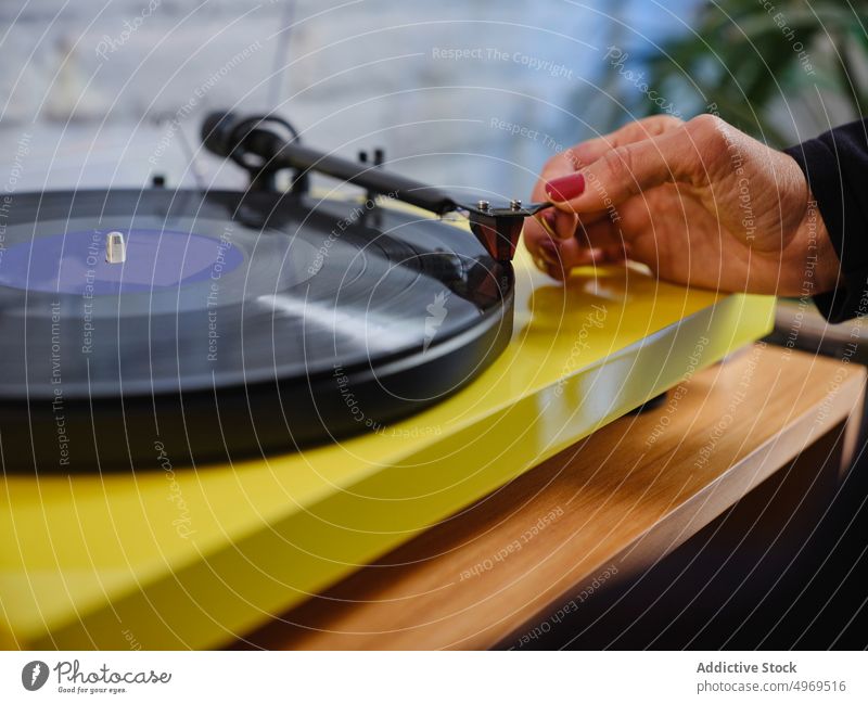 Woman putting vinyl record into record player music woman disc nostalgia listen elegant female hobby enjoy tune jacket vintage audio melody sound classic relax