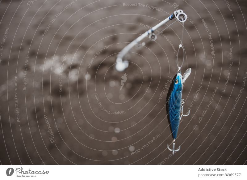 Fishing rod with plug in sea - a Royalty Free Stock Photo from Photocase