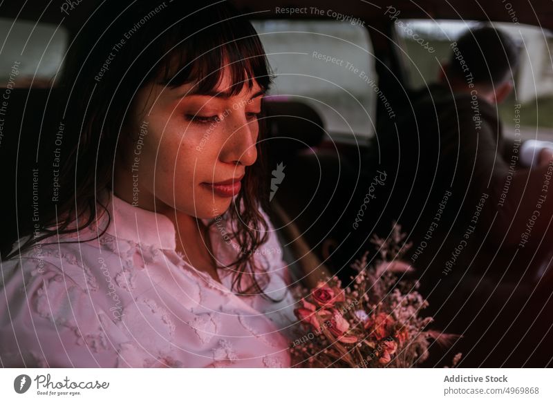 Cheerful bride with bouquet of flowers in car wedding newlywed smile groom together couple romantic love charming flora floral bunch tender white dress