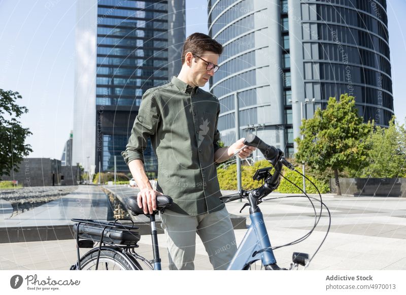 Stylish man with bicycle in city center urban downtown bike style modern street