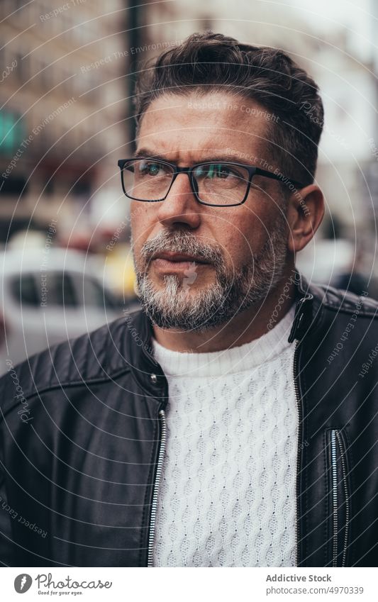 Serious mature male on street in city man thoughtful trendy middle aged masculine brutal personality individuality contemplate smart explore vacation