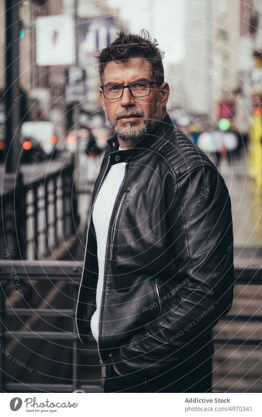 Serious mature male on street in city man thoughtful trendy middle aged masculine brutal personality individuality contemplate smart explore vacation