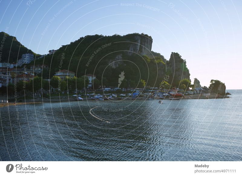 View on the beach and the rugged rocks in the bay of Amasra in the light of the evening sun in the province of Bartin on the coast of the Black Sea in Turkey