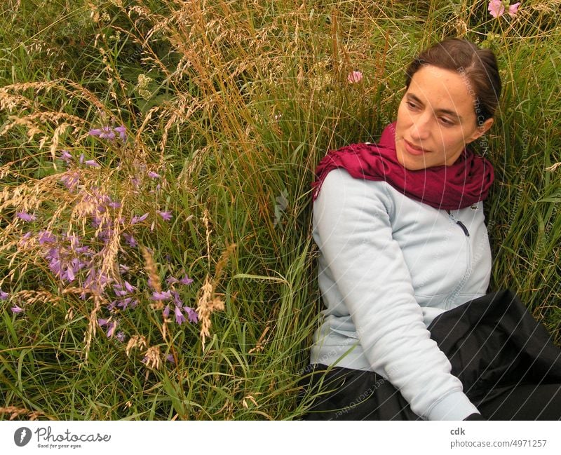 Lying in the tall grass and daydreaming. Adults Woman portrait Smiling Face Meadow Flower meadow look consider muse ponder feel Observe Summer Nature grasses