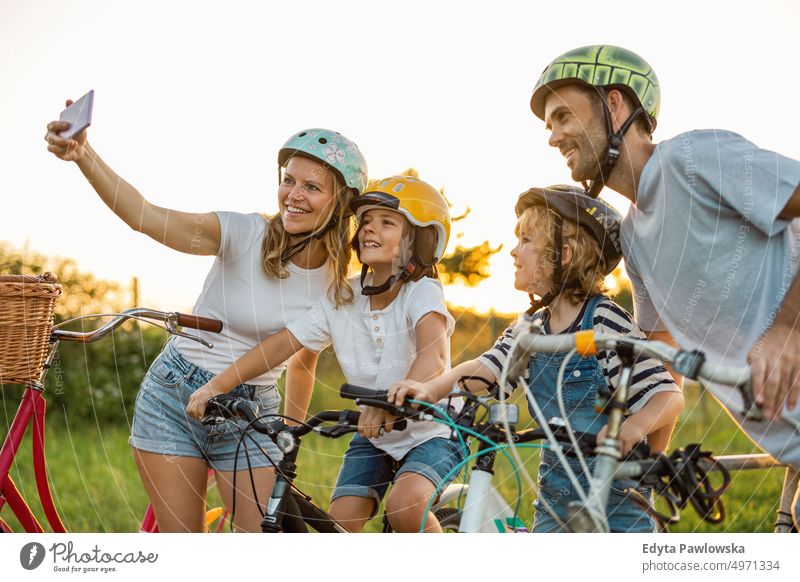 Family taking a selfie while on a bike ride day healthy lifestyle active lifestyle outdoors fun joy bicycle cycling biking activity cyclist enjoying ecological