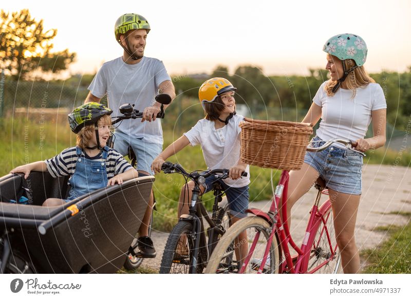 Happy family cycling together in the countryside day healthy lifestyle active lifestyle outdoors fun joy bicycle biking activity bike cyclist enjoying