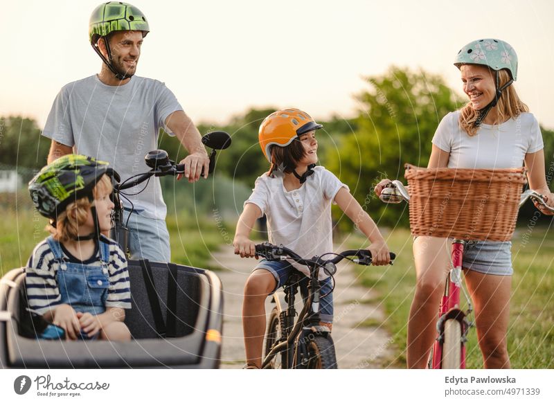 Happy family cycling together in the countryside day healthy lifestyle active lifestyle outdoors fun joy bicycle biking activity bike cyclist enjoying