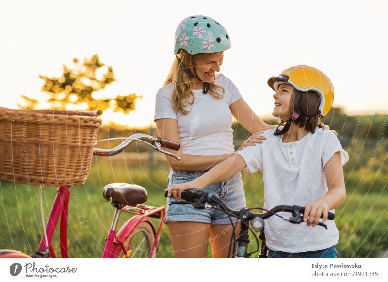 Mother and son enjoying a bike trip together day healthy lifestyle active lifestyle outdoors fun bicycle cycling biking activity cyclist ecological people happy