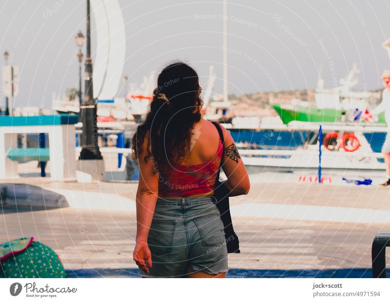 summer walk along the harbor Young woman Feminine Rear view 18 - 30 years Long-haired Agios Nikolaos Crete Greece Mediterranean Cloudless sky desaturated Top